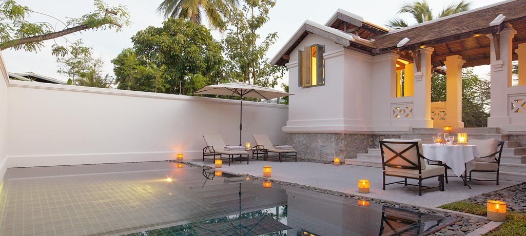 amantaka-pool-suite-laos-terrace-at-dusk-with-candles-and-dining-set-up.jpg